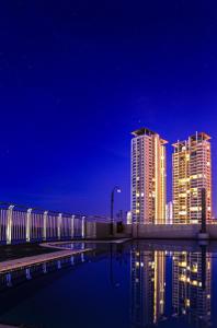 a city skyline with tall buildings at night at Leisure Cove Hotel and Apartments in George Town
