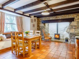 a dining room with a table and a fireplace at 2 Bed in Newquay 82370 in Mitchell