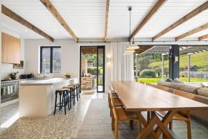 an open kitchen and dining room with a table and chairs at Hide and Seek, Kangaroo Valley in Upper Kangaroo River