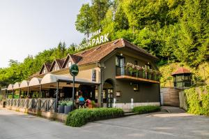 a building with a restaurant on the side of a street at Penzion Park in Laško