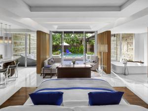a bedroom with a bed and a living room at Sofitel Bali Nusa Dua Beach Resort in Nusa Dua