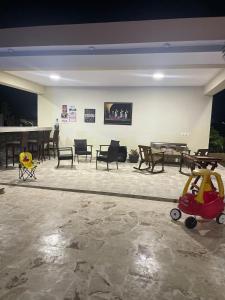 a living room with a table and chairs and a toy at Jeda Village in Higuey