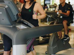 a woman walking on a treadmill in a gym at Grand Mercure Sao Paulo Ibirapuera in Sao Paulo +245 photos