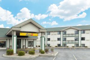 a hotel building with a cocacola sign in a parking lot at Super 8 by Wyndham Wisconsin Dells in Wisconsin Dells