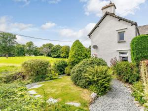an old house with a garden in front of it at 3 Bed in Hawkshead Village LLH40 in Hawkshead