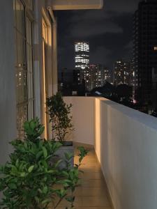 a balcony with a view of the city at night at Beachfront City Escape Sunset Balcony AC WiFi in Colombo
