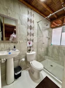 a bathroom with a toilet and a sink and a shower at Agencia Ecohuila in Villavieja