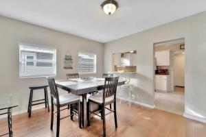 a kitchen and dining room with a table and chairs at Family & Pet Friendly Getaway with Porch Fire Pit & Yard in Tampa +41 photos