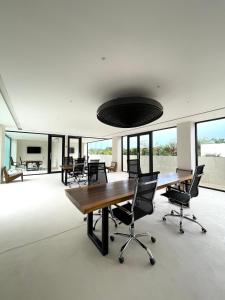 an office with desks and chairs and a large room with windows at Tulum Getaway with Jacuzzi & Pools in Tulum