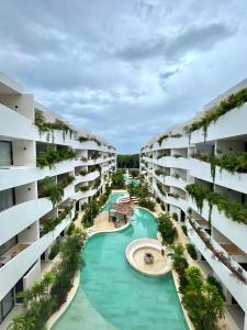 an aerial view of an apartment complex with a swimming pool at Tulum Getaway with Jacuzzi & Pools in Tulum