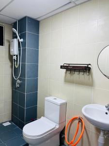 a bathroom with a toilet and a sink at FA Homestay KLIA 3rd Unit in Nilai +3 photos