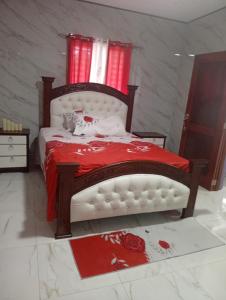a bedroom with a bed with a cat laying on it at Villa colombia in Miches