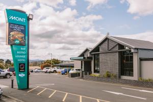 a gas station sign in front of a building at Claremont Hotel in Claremont