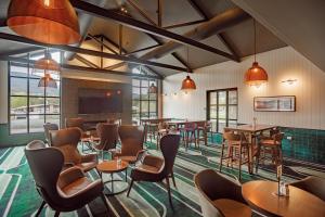 a restaurant with tables and chairs and windows at Claremont Hotel in Claremont +5 photos