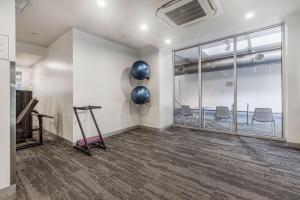 an empty room with chairs and a large window at 'Swanston Central' Wellness-infused City Living in Melbourne