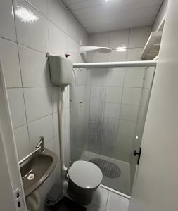 a small bathroom with a toilet and a sink at Apartamentos São Pedro da Aldeia in São Pedro da Aldeia +84 photos