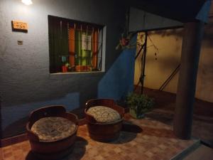 a room with three stools and a window at La Casa de Doña Adela in Eugenio Bustos