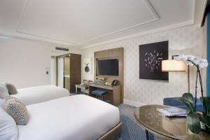 a hotel room with a bed and a table at The Star Grand at The Star Gold Coast in Gold Coast