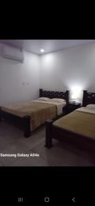 a room with two beds in a room at Villa Coral Gables in Puerto Jiménez