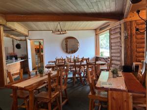 a large dining room with wooden tables and chairs at Anglemont Inn Rent all 16 Rooms for Weddings, Events North Shuswap BC in Anglemont