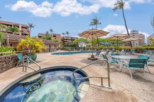 a pool with a hot tub and chairs and an umbrella at Kahana Villa F405 · KV F405 Perfect Maui Getaway Condo w Ocean V in Kahana