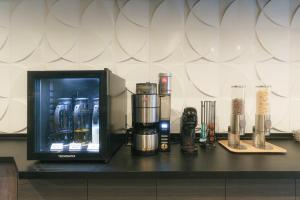 a counter with a coffee maker and other items on it at INOVA Kanazawa in Kanazawa