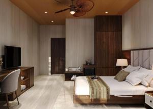 a bedroom with a large bed and a television at Nature Resort Vangvieng in Vang Vieng