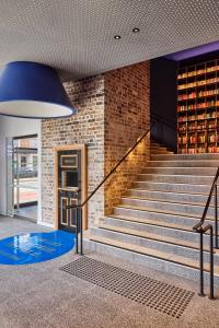 a staircase in a building with a blue ceiling at 25hours Hotel Sydney The Olympia in Sydney