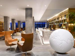 a lobby of a hotel with a large white ball at Pullman Abidjan in Abidjan