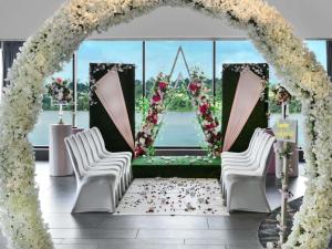 an arch with white chairs and flowers in a room at Pullman Abidjan in Abidjan +179 photos