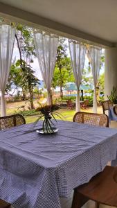 a table with a purple table cloth on a table with chairs at Rumah Arunika 27 