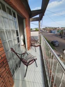 two chairs sitting on a porch of a house at Apartamento moderno y luminoso ,con 2 dormitorios in Rivera