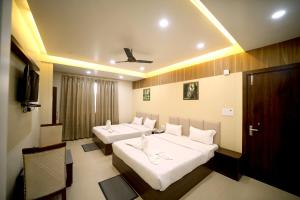 a hotel room with two beds and a tv at Hotel Royal Phoenix in Agra +119 photos