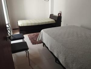 a bedroom with a bed and a bench and a rug at Apartamento moderno y luminoso ,con 2 dormitorios in Rivera