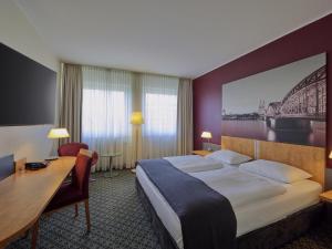 a hotel room with a bed and a desk at Mercure Hotel Severinshof Köln City in Cologne +72 photos