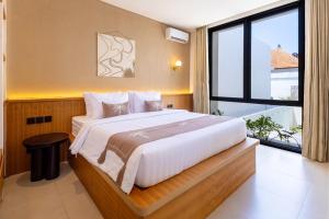 a bedroom with a large bed and a large window at Villa Tin in Pererenan +20 photos