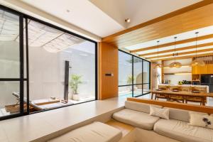 a living room with a couch and a table at Villa Tin in Pererenan