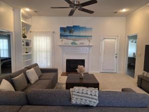 a living room with a couch and a fireplace at The Bama Bungalow 3BD Walk to the Game, Stay in Style in Tuscaloosa