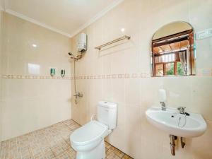 a bathroom with a toilet and a sink at Arovala Villa in Padasul +36 photos