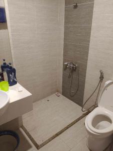 a bathroom with a shower with a toilet and a sink at Linh Kinh Bắc in Hòa Bình