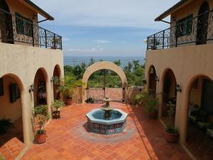 a courtyard with a fountain in the middle of a building at Wishingwell B&B in Donghe