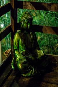 a green statue sitting on top of a table at rincon sukhino in Lo Narváez +4 photos