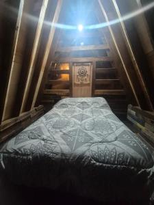 a large bed in a room with stairs at rincon sukhino in Lo Narváez
