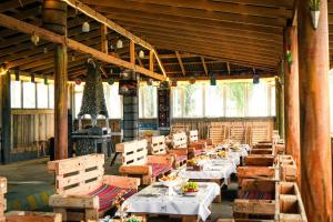a dining room with tables and chairs in a building at Jaichy Yurt Camp in Këk-Say