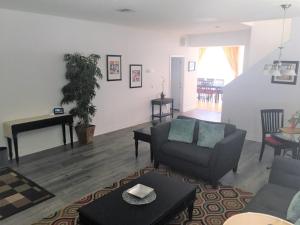 a living room with a couch and a piano at Berkeley Pool Home home in Kissimmee
