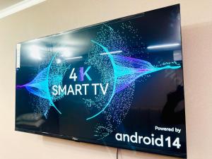 a sign for a smart tv on a wall at City Apartments in Oral