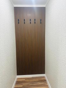 a closet with a wooden door in a room at City Apartments in Oral +2 photos
