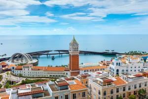 a view of a city with a clock tower at Atermis Regency Hillside Phu Quoc - Sea & Fireworks view- Gym & Pool Access in Phu Quoc