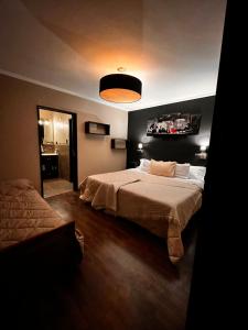 ein großes Schlafzimmer mit 2 Betten und einer Lampe in der Unterkunft Depto Boutique Chivilcoy in Chivilcoy