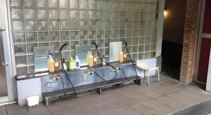 a bathroom with two sinks and two mirrors at Kakeyu Onsen Hotel Kameya in Ueda